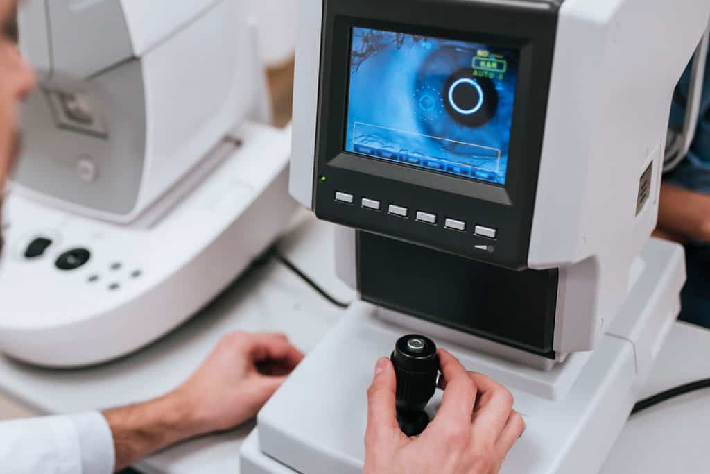 Close-up of an eye exam using autorefractor machine.
