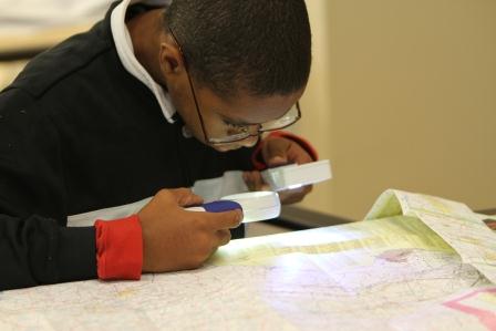 Child using a video magnifier to read a textbook